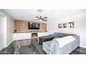 Cozy living room with wood accent wall, fireplace, built-in cabinets, and plush sofa at 2139 W Obispo Ave, Mesa, AZ 85202