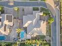Birds eye view of this homes backyard featuring a sparkling pool, lush landscaping, and cozy patio area at 21912 E Desert Hills Dr, Queen Creek, AZ 85142
