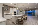 Bright kitchen featuring stainless steel appliances, a large island with seating, and sliding glass doors to the pool at 2339 E Questa Dr, Phoenix, AZ 85024