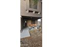 Covered front porch with decorative plants and a wooden swing, offering a welcoming entrance to the home at 23630 W Chambers St, Buckeye, AZ 85326