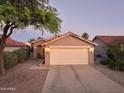 Home with desert landscaping and neutral-toned exterior featuring a spacious two-car garage at 2401 E Antigua Dr, Casa Grande, AZ 85194