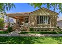 Charming single-Gathering home with a cozy front porch and manicured lawn at 2634 E Tamarisk St, Gilbert, AZ 85296