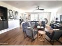 Open-concept living room with stylish seating and decor, hardwood flooring, and ample natural light at 2707 E James St, Gilbert, AZ 85296