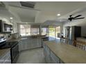Well-lit kitchen featuring a stainless steel refrigerator, stove, and microwave with outdoor views at 3738 W Danbury Dr, Glendale, AZ 85308