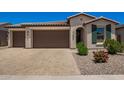 Beautiful home with a spacious three car garage and well-manicured landscaping at 40470 W Agave Rd, Maricopa, AZ 85138