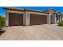 Lovely home featuring a spacious three-car garage and a paved driveway at 40470 W Agave Rd, Maricopa, AZ 85138