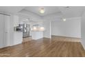 Bright, open living area featuring wood floors and a modern kitchen with stainless steel appliances at 4200 N Miller Rd # 325, Scottsdale, AZ 85251