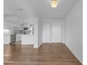 Open-concept living area with wood floors flowing into a modern kitchen featuring stainless steel appliances at 4200 N Miller Rd # 325, Scottsdale, AZ 85251