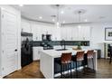 Modern kitchen features white cabinets, a large island, and stainless steel appliances at 4543 S Nebula --, Mesa, AZ 85212