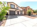 Traditional two-story home features a welcoming entrance, attached garage, and a well-kept front yard, providing a cozy and inviting appeal at 4925 S 5Th Ave, Phoenix, AZ 85041