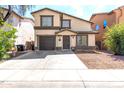 Inviting two-story home with an attached garage and a well-manicured front yard, offering a blend of comfort and curb appeal at 4925 S 5Th Ave, Phoenix, AZ 85041