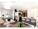 Open-concept living room with a modern kitchen featuring a central island and stylish seating, creating a perfect space for entertaining at 4925 S 5Th Ave, Phoenix, AZ 85041