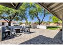 Outdoor patio area featuring brick pavers, comfortable seating, and lush trees at 5112 E Cholla St, Scottsdale, AZ 85254