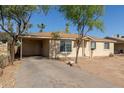 Cozy single-story home with a convenient covered carport, offering shelter and convenience at 6139 N 31St Dr, Phoenix, AZ 85017
