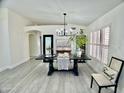 Bright dining room with rustic table, modern chandelier, and neutral decor at 6626 W Monona Dr, Glendale, AZ 85308