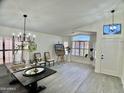 Bright dining room featuring white walls, plantation shutters, and decorative furnishings at 6626 W Monona Dr, Glendale, AZ 85308