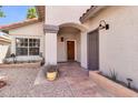 Home's covered front entry, highlighting tiled walkway and desert-style landscaping at 6837 S Roosevelt St, Tempe, AZ 85283