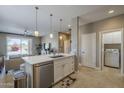 Bright open-concept kitchen with a large island, modern stainless steel appliances, and seamless flow to living area at 6847 S 27Th Pl, Phoenix, AZ 85042