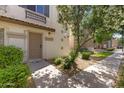 Charming condo entrance with a well-maintained door, beautiful flowering tree, and landscaped front yard at 753 N Port Dr, Gilbert, AZ 85233