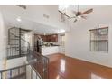 Lofted living space with a spiral staircase, wood flooring, and a view of the kitchen at 753 N Port Dr, Gilbert, AZ 85233