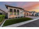 Charming single-Gathering home boasts a paver driveway, two-car garage, and manicured front yard with beautiful desert plants at 8127 E June St, Mesa, AZ 85207