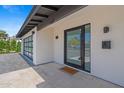 Welcoming front entrance with a modern door, stylish lighting fixtures, and a decorative welcome mat at 8430 E Fairmount Ave, Scottsdale, AZ 85251