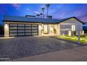 Charming home with a modern garage, and a well-lit walkway. Palm trees add to the curb appeal at 8430 E Fairmount Ave, Scottsdale, AZ 85251