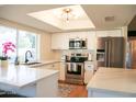 Bright kitchen featuring stainless steel appliances, white cabinets, and a large window for natural light at 864 W Monte Ave, Mesa, AZ 85210