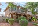 A view of the house with well-maintained landscaping, showcasing the lush greenery and curb appeal at 999 S Sabino Dr, Gilbert, AZ 85296