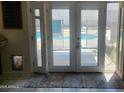 View from inside through an open white patio door with a glimpse of the pool outside at 10201 S 49Th St, Phoenix, AZ 85044