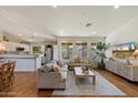 Spacious living area featuring a hardwood floor, recessed lights, and open to the kitchen area at 10239 E Salt Bush Dr, Scottsdale, AZ 85255
