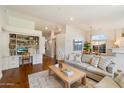 Open-concept living space with hardwood floors, built-in shelving, and views into the dining room at 10239 E Salt Bush Dr, Scottsdale, AZ 85255