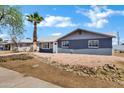 Well-maintained home featuring desert landscaping, gray brick and a charming front entrance at 1027 S Lola Ln, Tempe, AZ 85281