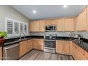 Modern kitchen featuring stainless steel appliances, wood cabinets, and black countertops at 1028 W Chilton Ave, Gilbert, AZ 85233