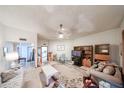 Spacious living room with dining area, and neutral colored carpet at 10401 W Loma Blanca Dr, Sun City, AZ 85351