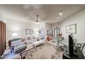 A spacious living room with a glass top dining table, carpet, and a sliding door at 10401 W Loma Blanca Dr, Sun City, AZ 85351