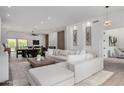 Open-concept living space with a sectional sofa, adjoining dining area, and stylish decor, perfect for modern living at 11662 E Parkview Ln, Scottsdale, AZ 85255