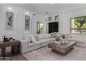 Bright living room featuring a sectional sofa, modern decor, recessed lighting, and neutral color palette at 11662 E Parkview Ln, Scottsdale, AZ 85255