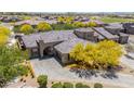 Beautiful aerial view showcases this home, its desert landscaping, tile roof, and paver driveway in a well-kept neighborhood at 12325 S 179Th S Ave # 0, Goodyear, AZ 85338
