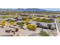 Expansive aerial shot highlighting the home's desert landscape, paver driveway, golf course, and surrounding community at 12325 S 179Th S Ave # 0, Goodyear, AZ 85338