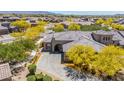Stunning aerial view of a home with desert landscaping, tile roof, and a paver driveway in a vibrant community at 12325 S 179Th S Ave # 0, Goodyear, AZ 85338