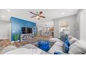 Open-concept living space with stylish blue accent wall and inviting seating area at 1250 N Abbey Ln # 275, Chandler, AZ 85226