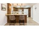 Charming kitchen features granite countertops, wooden cabinetry, and a modern refrigerator at 12739 W Prospect Dr, Sun City West, AZ 85375
