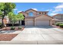 Charming two-story home with a three car garage and landscaped front yard at 13965 N 135Th Dr, Surprise, AZ 85379
