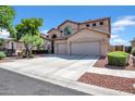 Charming two-story home with a three car garage and landscaped front yard at 13965 N 135Th Dr, Surprise, AZ 85379