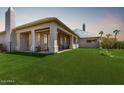 Backyard features a covered patio, artificial turf, and a fence for added privacy at 16540 E El Lago Blvd # 2, Fountain Hills, AZ 85268