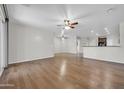 Spacious living room with hardwood floors, ceiling fans, and abundant natural light at 17429 W Red Bird Rd, Surprise, AZ 85387