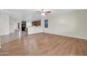Open-concept living room with hardwood floors and a view of the kitchen at 17429 W Red Bird Rd, Surprise, AZ 85387