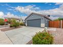 A well-maintained home with desert landscaping, a two-car garage, and a clean, modern exterior design at 18415 W Surprise Farms N Loop, Surprise, AZ 85388