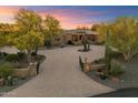 Grand estate featuring desert landscaping, a circular driveway, and a gated entrance to a private oasis at 22610 N 80Th Pl, Scottsdale, AZ 85255